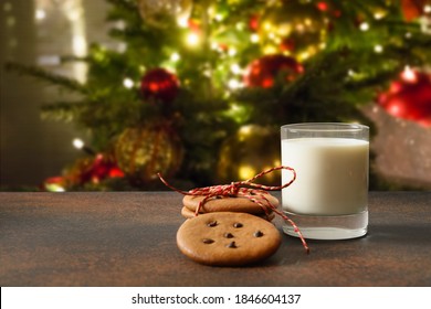 Christmas cookies and glass of milk for Santa near Xmas tree. - Powered by Shutterstock