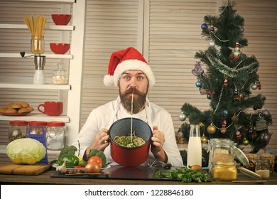 Christmas Cookies At Man Cook In Kitchen. Thanksgiving Day And Christmas. Family Dinner And New Year Recipe. New Year Cuisine, Menu And Food. Chef Man In Santa Claus Hat Cooking. Turkey, Pasta, Dish.