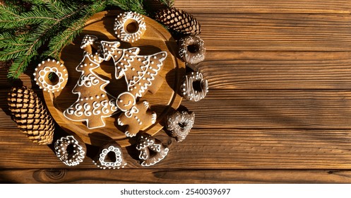 Christmas Cookies on Wooden Platter with Chocolate Treats. A festive spread of gingerbread cookies shaped like trees, wreaths, and gingerbread people alongside chocolate-covered treats. Top view. Copy - Powered by Shutterstock