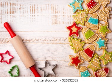 Christmas cookies, rolling pin and cookie cutters on the wooden background. - Powered by Shutterstock