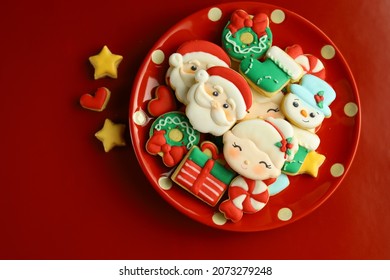 Christmas cookies with royal icing decorations. Top view with Red background