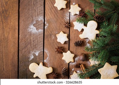 Christmas cookies and tinsel on a dark wooden background. Top view ภาพถ่ายสต็อก