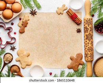 Christmas cooking background. Baking paper and gingerbreag cookies ingredients (spices, cinnamon, nutmeg powder, eggs and brown sugar) on white background. Copy space. Top view. Flatlay. Layout design - Powered by Shutterstock