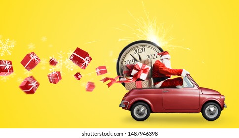Christmas countdown arriving. Santa Claus on snowy toy car delivering New Year gifts and clock at yellow background