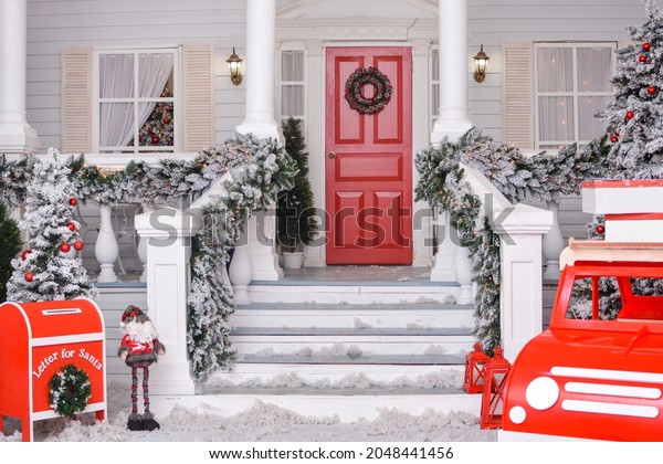 Christmas courtyard with\
Christmas porch, veranda, wreath, Christmas tree, red car, gnome,\
letterbox for Santa Claus, lanterns, garland. Merry Christmas and\
Happy New Year