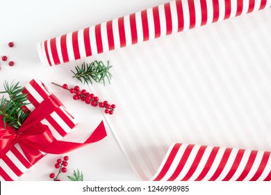 Christmas cozy composition. Xmas red gifts and decorations, paper on white background. Christmas, New Year, winter concept. Flat lay, top view, copy space
