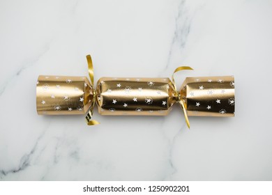 Christmas crackers. luxury gold and black festive crackers on a marble background