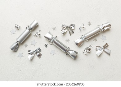 Christmas crackers with shiny confetti on color background, top view, copy space. - Powered by Shutterstock