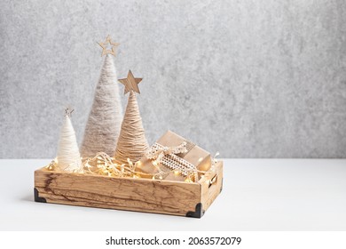 Christmas Craft Background With Handmade Yarn Cone Xmas Trees In Natural Colors.  DIY Organic Sustainable Christmas Decoration