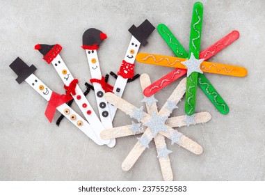 Christmas crafts with popsicle sticks. Tiny snowmen with Stars ornaments or snowflakes - Powered by Shutterstock