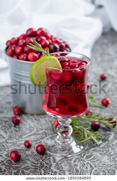 Christmas cranberry drink with berries, lime, and\
rosemary. Copy space.