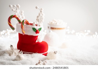 Christmas creative composition made with Santa boots with sweets and gifts on snow background. Minimal New Year shopping season concept. Winter holidays idea. - Powered by Shutterstock