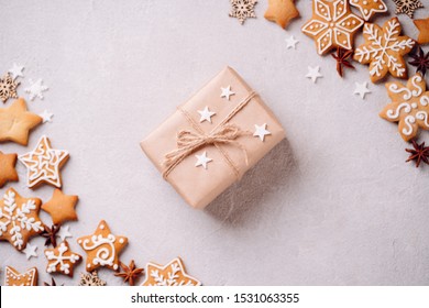 Christmas Creative Holiday Present. Handmade Paper Gift Box With Festive Food Decorations And Gingerbread Cookies On Stone Background. Copy Space.