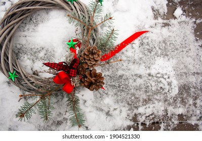 Christmas crown on rustic winter background with pine nuts and stars