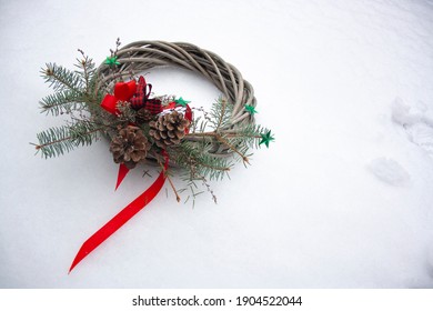 Christmas crown on white snow background with pine nuts and stars