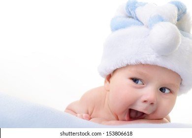 Christmas Cute Baby Boy Lying On Blue Soft Plaid Like On Snowdrift, Beautiful Funny Infant In Santa's Hat