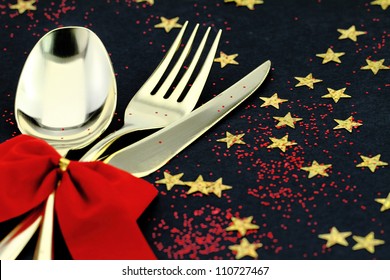 Christmas cutlery. Spoon, fork and knife stacked up on a starry background