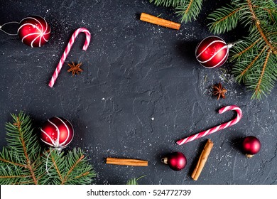 Christmas dark background with christmas decoration, christmas candy canes, fir branch, top view - Powered by Shutterstock