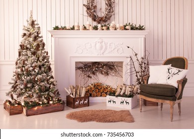 Christmas Decor Of A Bright Stylish Living Room With A Vintage Armchair, Fireplace, Christmas Tree And Candles