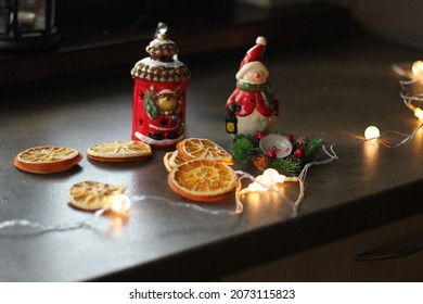 Christmas Decor On The Table. Flashlight, Garland, Dried Orange, Snowman