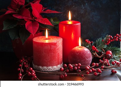 Christmas decor with red candles and poinsettia - Powered by Shutterstock