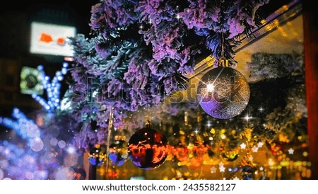 Christmas decoration, a branch of a fir tree in the snow, shining with different colors, a shiny New Year's ball, a bright festive background, different colors, a postcard