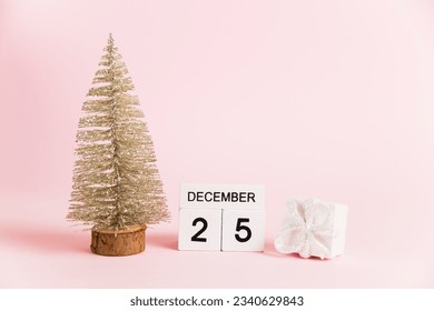 Christmas decoration and calendar with date December 25 on pink paper background with copy space. Christmas and New Year celebration concept - Powered by Shutterstock