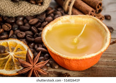  Christmas Decoration . Coffee Beans, Candle, Orange, Anise On Wooden Table.