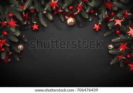 Christmas decoration with fir branches and red berries on a dark background
