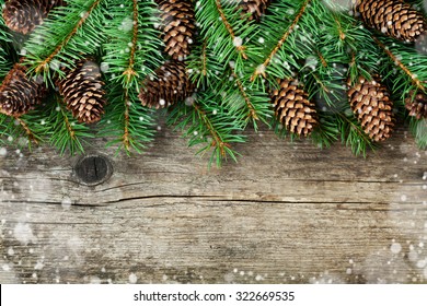 Christmas Decoration Of Fir Tree And Conifer Cone On Texture Wood Background, Magic Snow Effect, Top View 