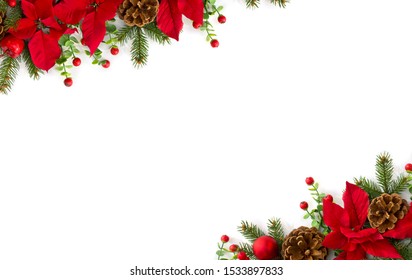 Christmas decoration. Frame of flowers of red poinsettia, branch christmas tree, ball, red berry on a white background with space for text. Top view, flat lay