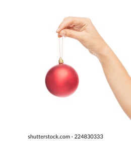 Christmas, Decoration, Holidays And People Concept - Close Up Of Woman Hand Holding Christmas Ball