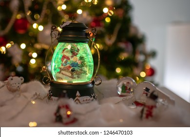 Christmas Decoration, Snow Dome, Globe With Table Decoration, Santaclaus On Sleigh With Child In Winter Scene With Snowflakes, Reindeer Snowglobe And Polar Bears, Tree In Background