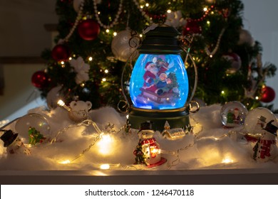 Christmas Decoration, Snow Dome, Globe With Table Decoration, Santaclaus On Sleigh With Child In Winter Scene With Snowflakes, Reindeer Snowglobe And Polar Bears, Tree In Background