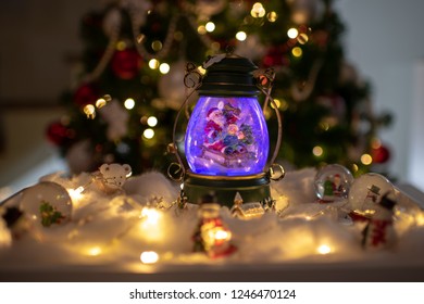 Christmas Decoration, Snow Dome, Globe With Table Decoration, Santaclaus On Sleigh With Child In Winter Scene With Snowflakes, Reindeer Snowglobe And Polar Bears, Tree In Background