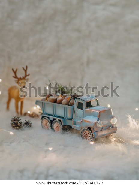 Christmas decoration, in the snow with lights\
garland machine with nuts and\
deer