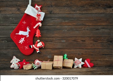 Christmas decoration stocking and toys hanging over rustic wooden background - Powered by Shutterstock