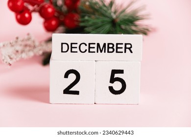 Christmas decoration tree branch and calendar with date December 25 on pink paper background with copy space. Christmas and New Year celebration concept - Powered by Shutterstock