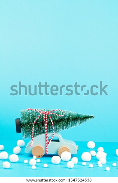 Christmas decoration with wooden car, pine tree,\
with copy space. Season greeting card, party invitation, christmas\
celebration concept