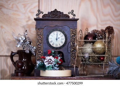Christmas decorations and clock on table on christmas holidays eve.