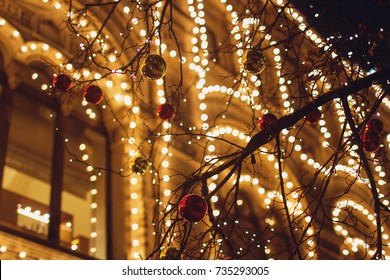 Christmas decorations on the street, colorful holiday bokeh lights, city night illumination, abstract blurry festive background