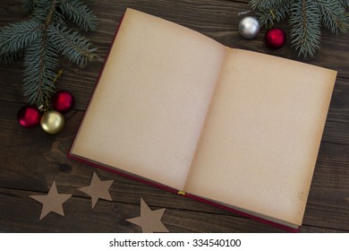 Christmas Decorations And An Open Book  On The Table