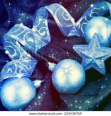 Christmas decorations and ribbon on a blue background