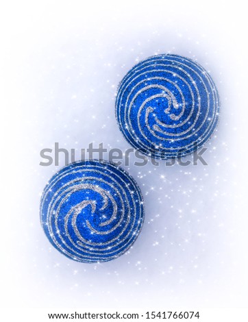 Christmas decorations with a sprial pattern shine with glare on the snow in winter. Christmas holiday background