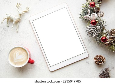 Christmas decorations and tablet on white concrete background. Christmas and New Year theme. Flat lay, top view, space for text - Powered by Shutterstock