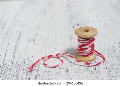 Christmas Decorative Red And White Thread In Light Wooden Background. Space For Text