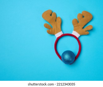 Christmas Deer Costume With Antlers On The Head On A Blue Background, Top View.