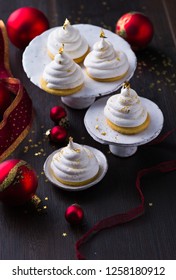 Christmas Dessert. Meringue Cup Cake With Gold Leaf On Decorated Table