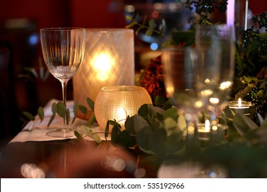Christmas dining table fully dressed with decorations and foliage.