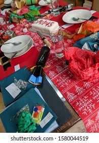 Christmas Dinner After The Party. Messy Table With Leftovers, Empty Plates And Cake. Vertical With Dutch Tilt.